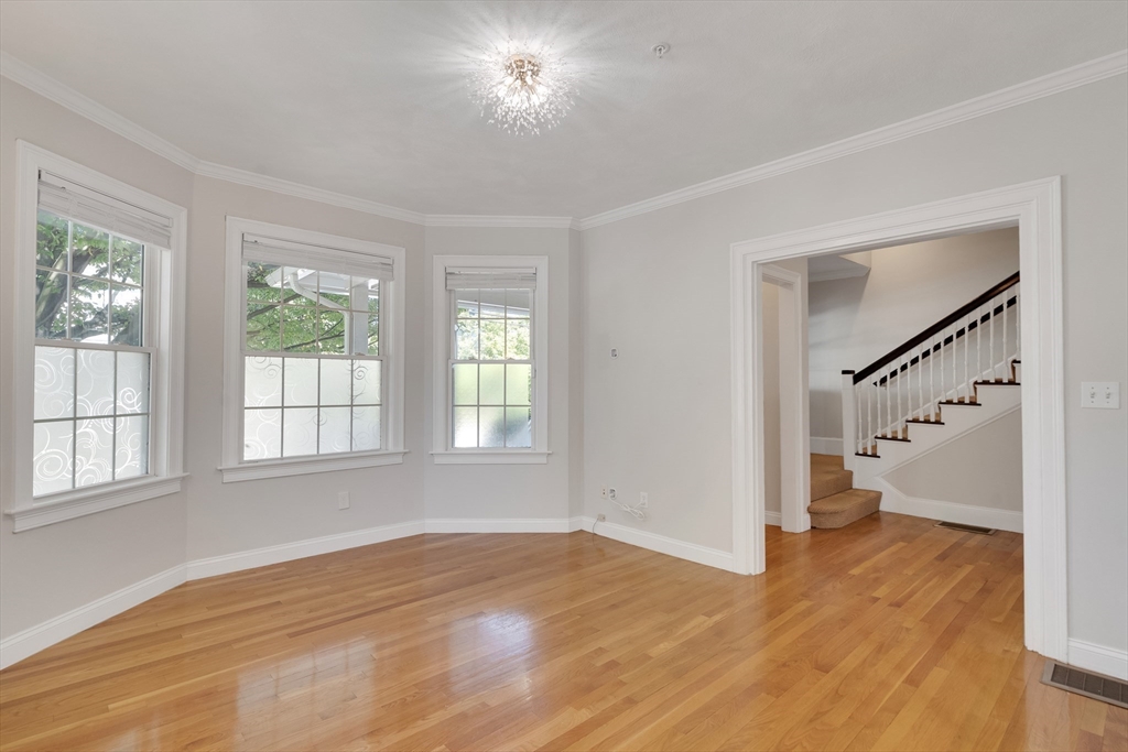 66 Webster Street, Unit 66 Newton, MA 02465 - Photo 5 of 40 a view of empty room with wooden floor and fan