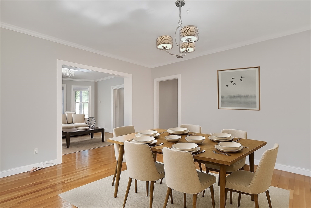66 Webster Street, Unit 66 Newton, MA 02465 - Photo 8 of 40 a view of a dining room with furniture wooden floor and chandelier