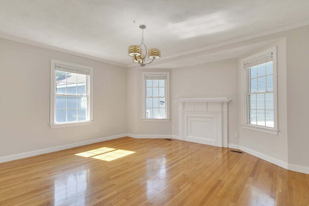 66 Webster Street, Unit 66 Newton, MA 02465 - Photo 9 of 40 a view of empty room with wooden floor and fan