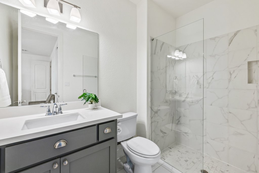 5812 Davenport Divide Road Austin, TX 78738 - Photo 29 of 40 Crisp quartz countertops and soft gray cabinetry give this bath a fresh, modern feel.