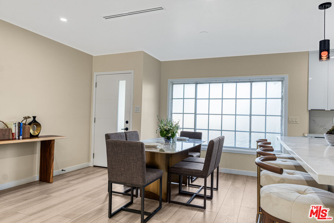 3500 Tuller Avenue Los Angeles, CA 90034 - Photo 7 of 20 a view of a dining room with furniture and wooden floor