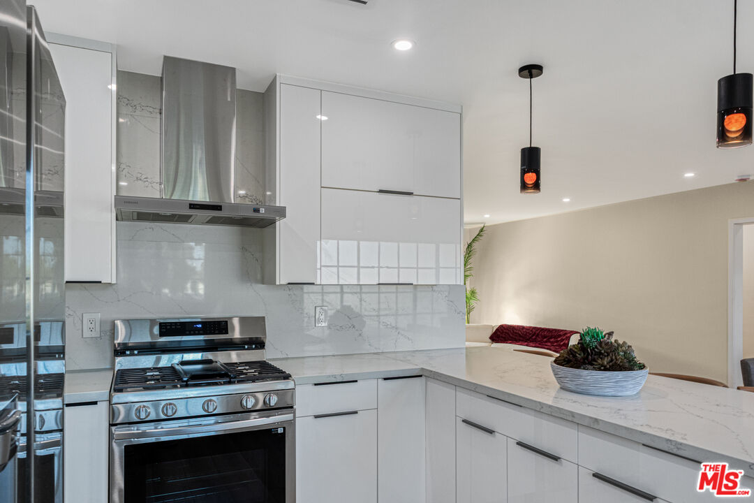 3500 Tuller Avenue Los Angeles, CA 90034 - Photo 8 of 20 a kitchen with stainless steel appliances granite countertop a sink stove and cabinets