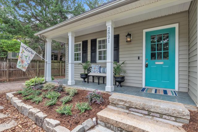 a backyard of a house with table and chairs