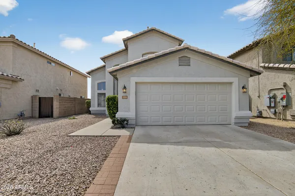 a view of a house with a yard and garage