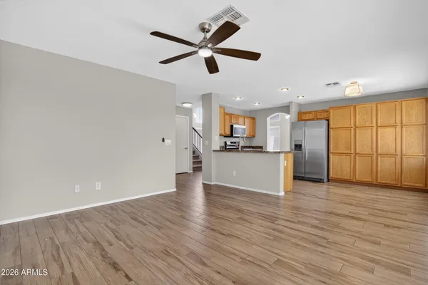 a kitchen with stainless steel appliances granite countertop a refrigerator a stove top oven a sink and dishwasher