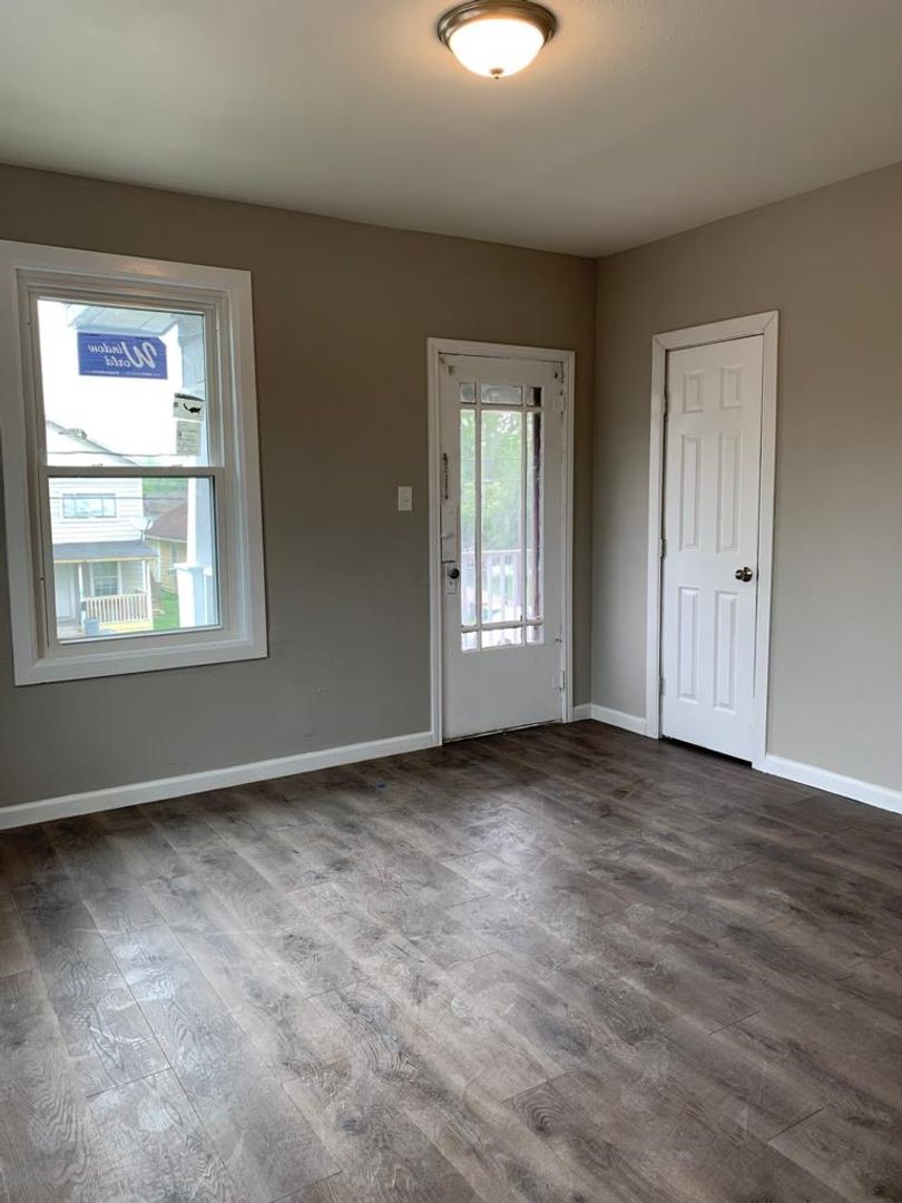 211 East Sterling Avenue, Unit 4 Baytown, TX 77520 - Photo 2 of 7 an empty room with windows