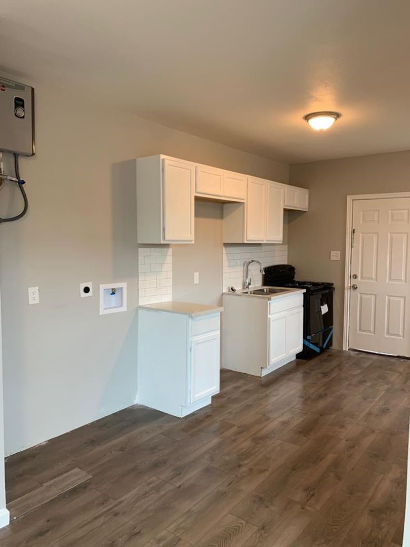 211 East Sterling Avenue, Unit 4 Baytown, TX 77520 - Photo 3 of 7 a view of kitchen with wooden floor