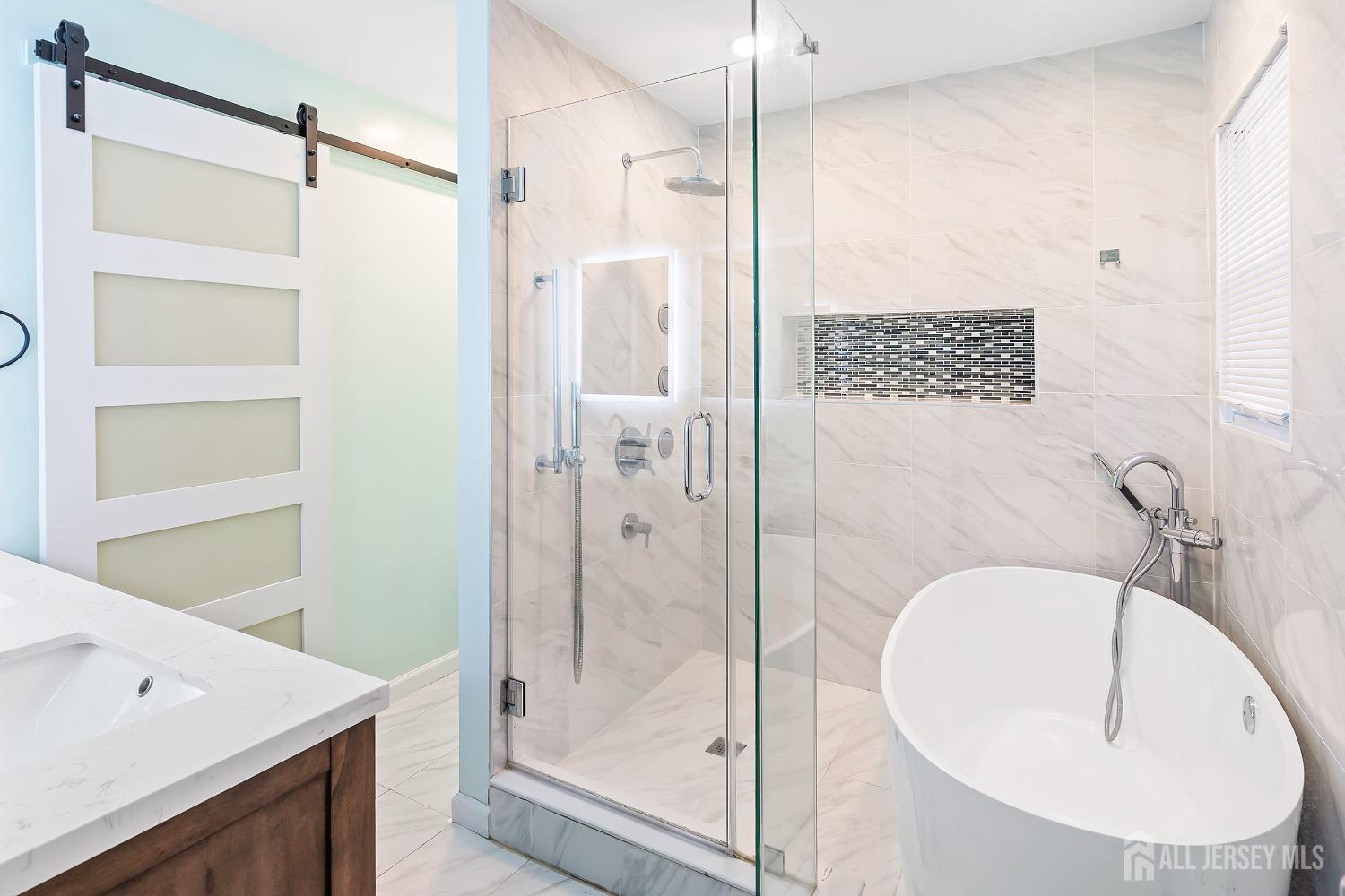 10 Woodruff Road Edison, NJ 08820 - Photo 11 of 18 a bathroom with a sink a mirror and a shower