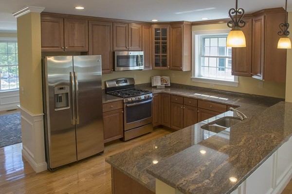 6 Robinson Road, Unit 10 Lexington, MA 02420 - Photo 3 of 6 a kitchen with stainless steel appliances granite countertop a sink a stove and a refrigerator