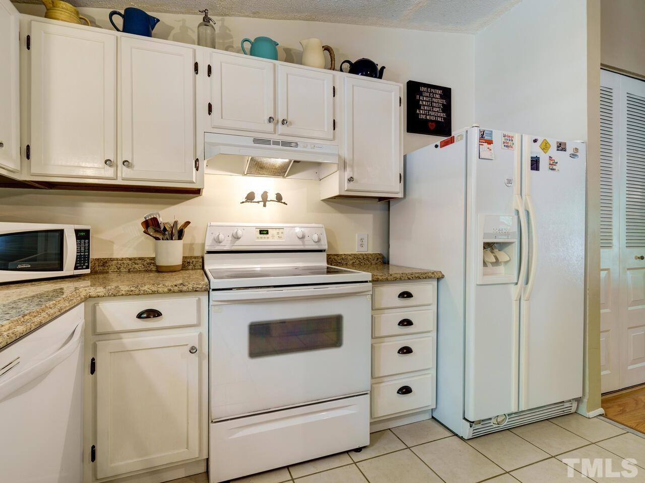 7249 Mine Shaft Road Raleigh, NC 27615 - Photo 11 of 45 a kitchen with white cabinets and white appliances