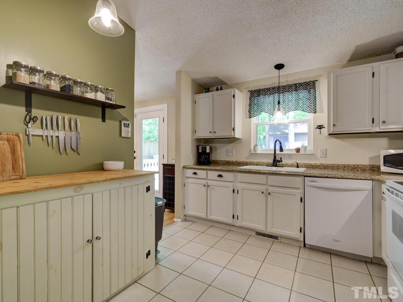 7249 Mine Shaft Road Raleigh, NC 27615 - Photo 13 of 45 a kitchen with cabinets and window