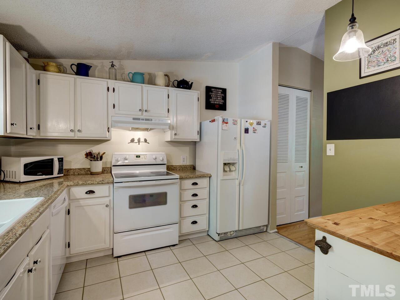 7249 Mine Shaft Road Raleigh, NC 27615 - Photo 14 of 45 a kitchen with cabinets stainless steel appliances and sink