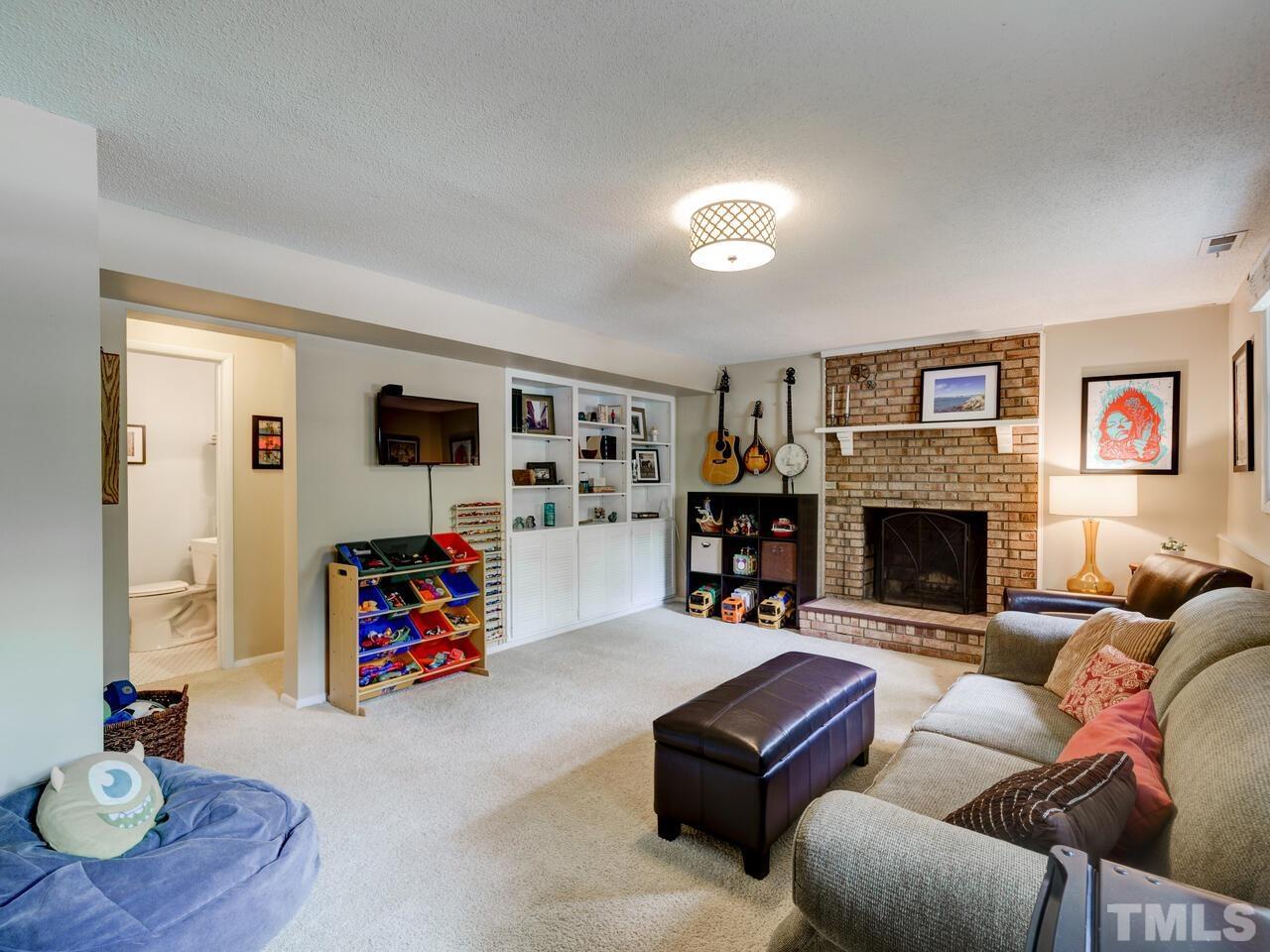 7249 Mine Shaft Road Raleigh, NC 27615 - Photo 15 of 45 a living room with furniture and a fireplace