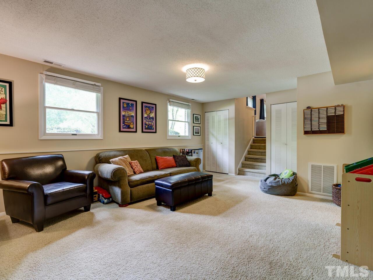 7249 Mine Shaft Road Raleigh, NC 27615 - Photo 16 of 45 a living room with furniture and a flat screen tv