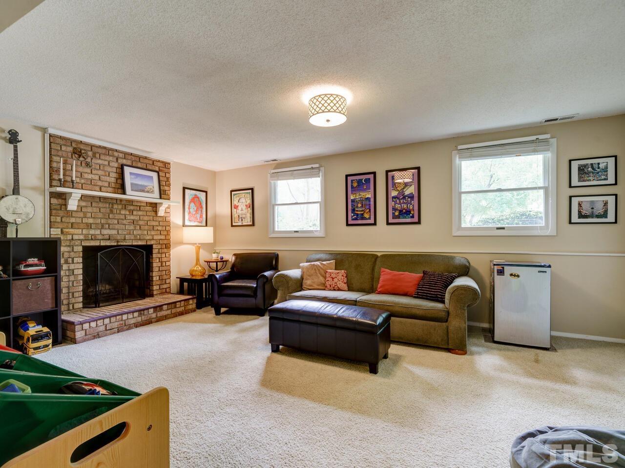 7249 Mine Shaft Road Raleigh, NC 27615 - Photo 17 of 45 a living room with furniture and a fireplace