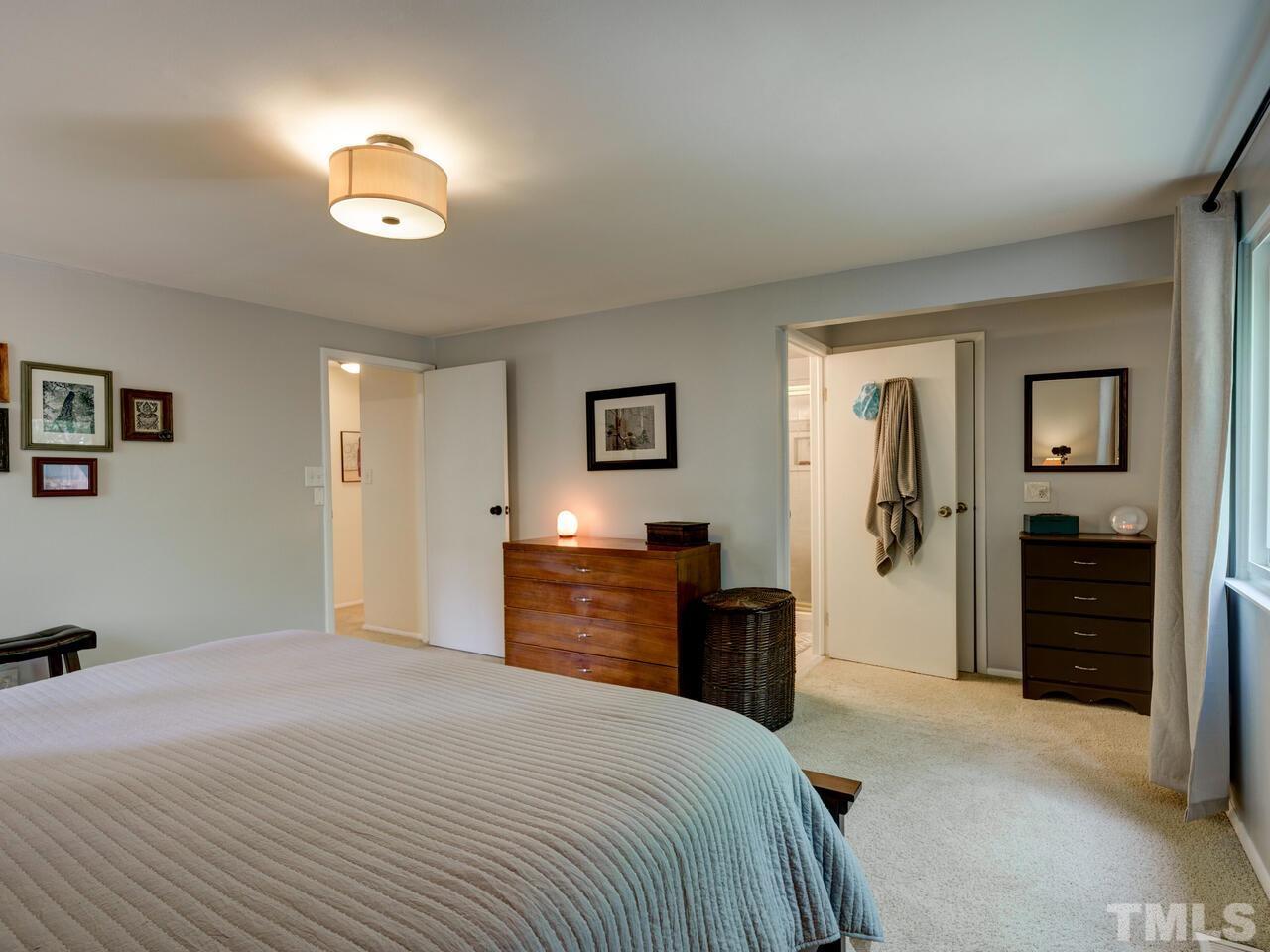 7249 Mine Shaft Road Raleigh, NC 27615 - Photo 20 of 45 a bedroom with a bed and a television
