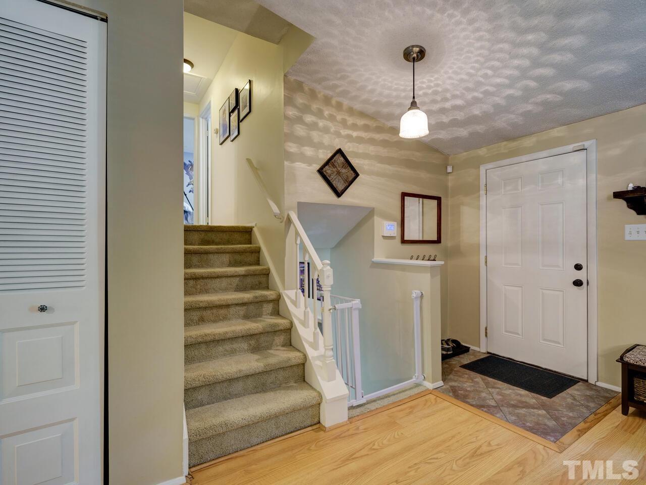 7249 Mine Shaft Road Raleigh, NC 27615 - Photo 3 of 45 a view of entryway and hall with wooden floor