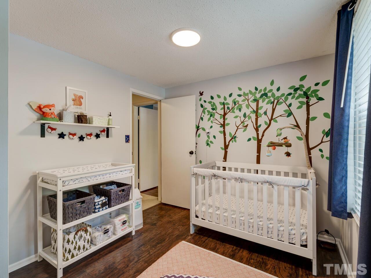 7249 Mine Shaft Road Raleigh, NC 27615 - Photo 25 of 45 a bedroom with furniture and a baby crib