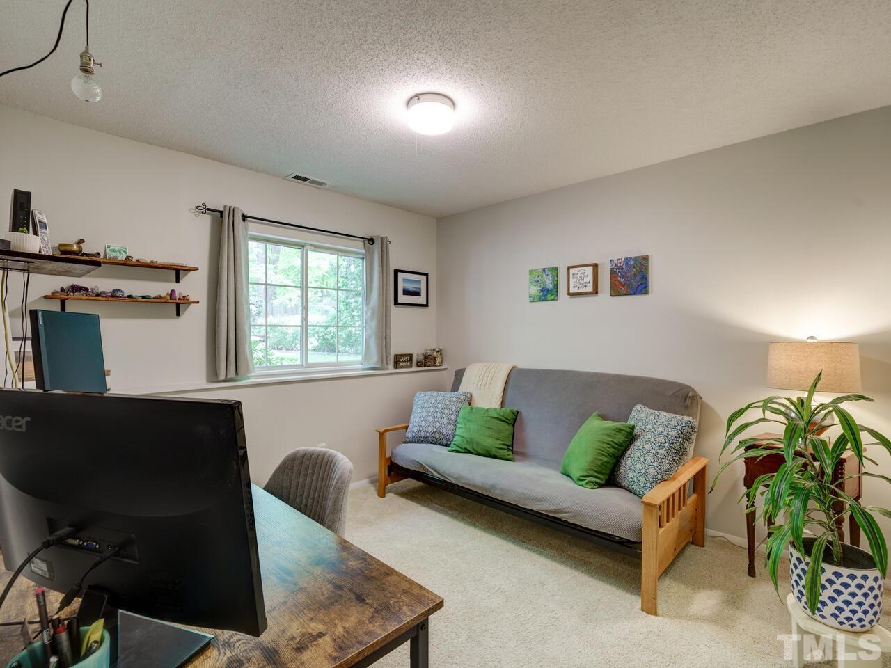 7249 Mine Shaft Road Raleigh, NC 27615 - Photo 27 of 45 a living room with furniture and a potted plant