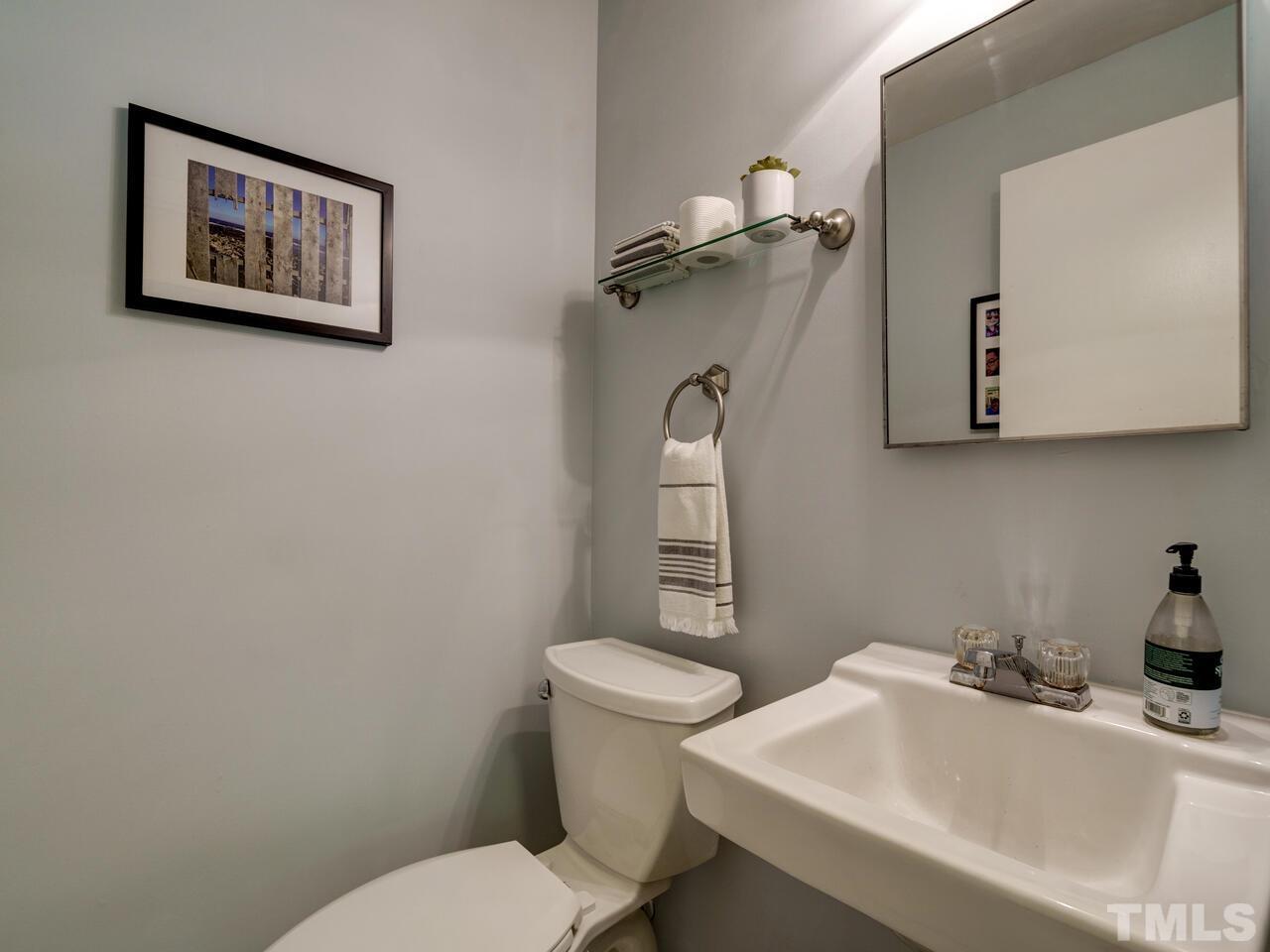 7249 Mine Shaft Road Raleigh, NC 27615 - Photo 29 of 45 a bathroom with a toilet a sink and mirror