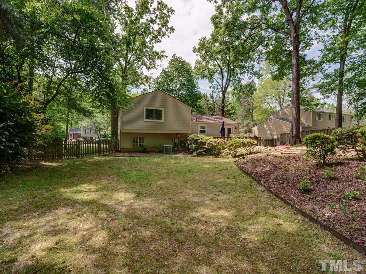 7249 Mine Shaft Road Raleigh, NC 27615 - Photo 33 of 45 a backyard of a house with yard and outdoor seating