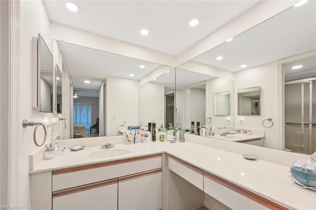 492 Veranda Way, Unit E105 Naples, FL 34104 - Photo 15 of 34 a bathroom with a sink double vanity and a mirror