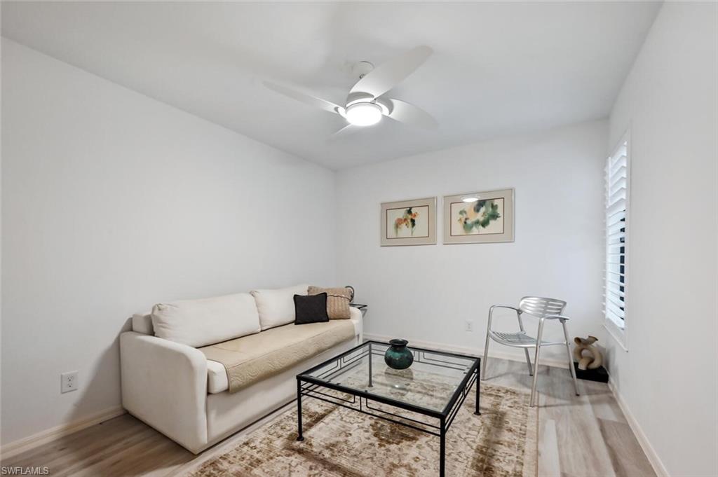 492 Veranda Way, Unit E105 Naples, FL 34104 - Photo 17 of 34 a living room with furniture and a rug