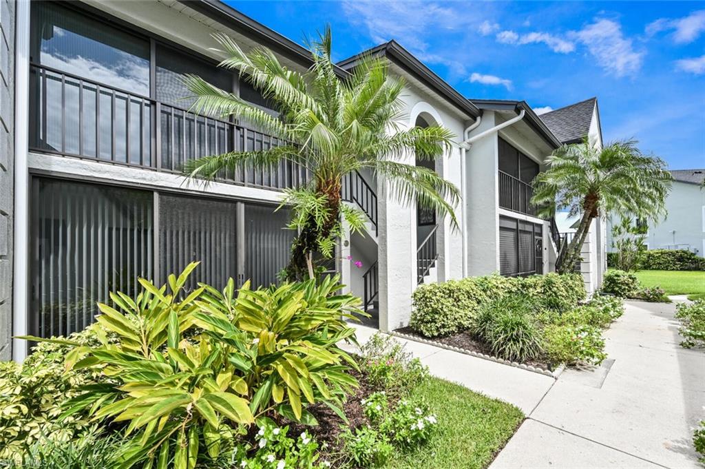 492 Veranda Way, Unit E105 Naples, FL 34104 - Photo 20 of 34 a view of a house with a flower garden