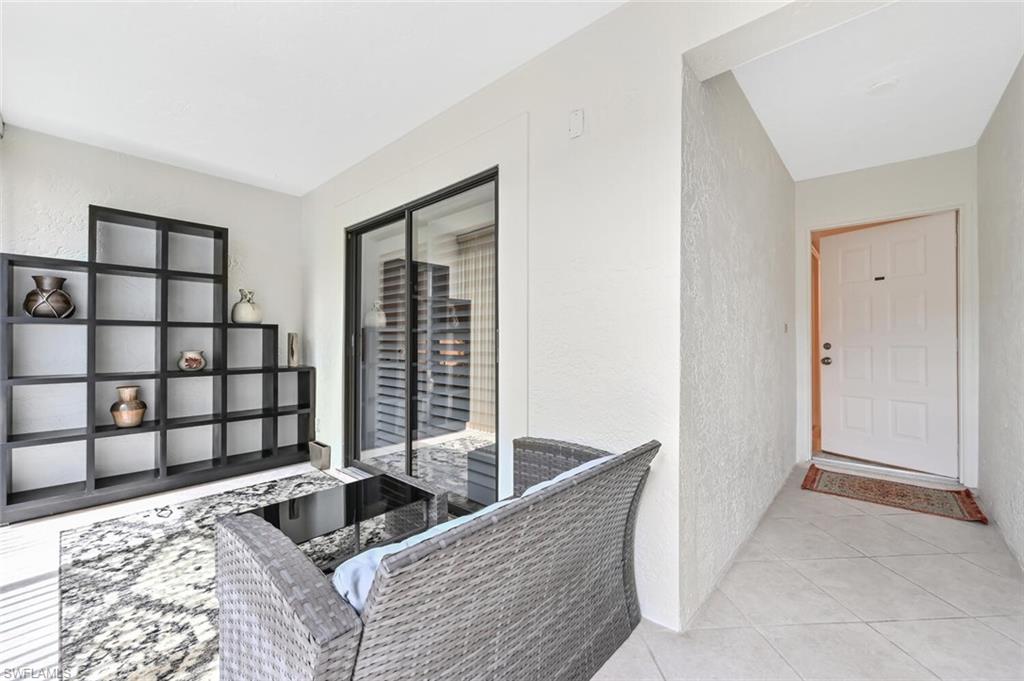 492 Veranda Way, Unit E105 Naples, FL 34104 - Photo 2 of 34 a living room with a couch