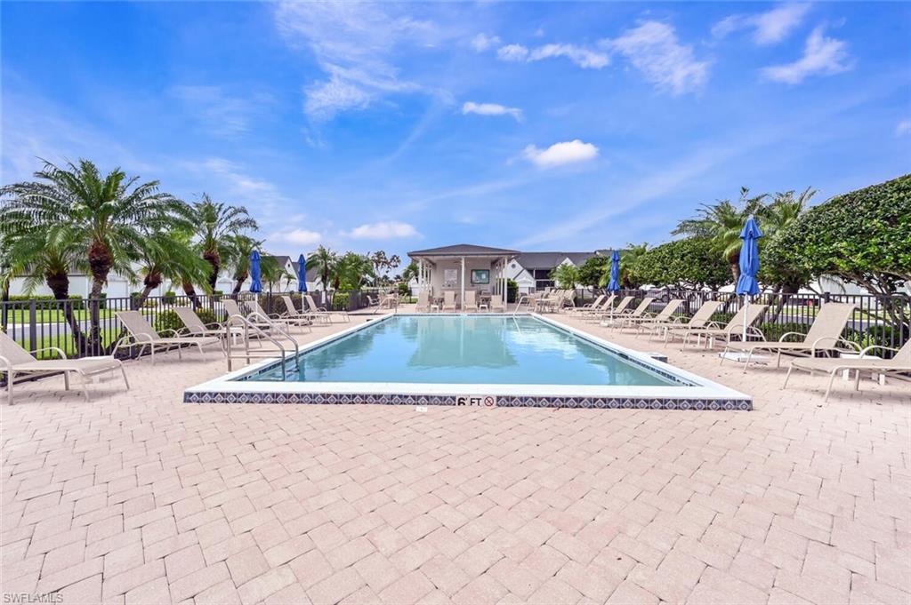 492 Veranda Way, Unit E105 Naples, FL 34104 - Photo 22 of 34 a view of a swimming pool with a yard