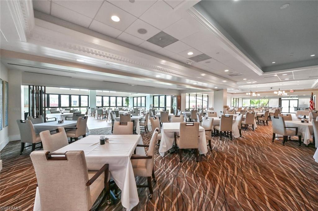 492 Veranda Way, Unit E105 Naples, FL 34104 - Photo 26 of 34 a very nice looking dining room with lots of furniture and wooden floor