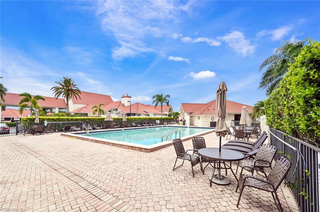 492 Veranda Way, Unit E105 Naples, FL 34104 - Photo 30 of 34 a view of a patio with a table and chairs