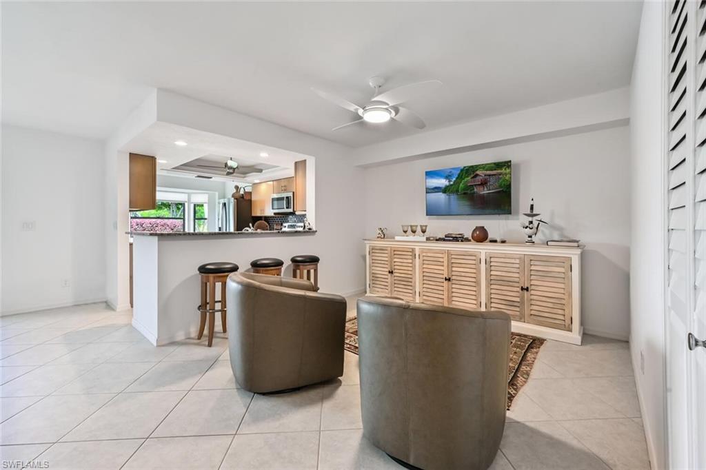 492 Veranda Way, Unit E105 Naples, FL 34104 - Photo 3 of 34 a room with furniture and flat screen tv