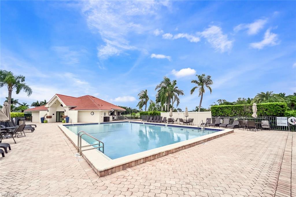 492 Veranda Way, Unit E105 Naples, FL 34104 - Photo 31 of 34 a view of a swimming pool with a lounge chairs