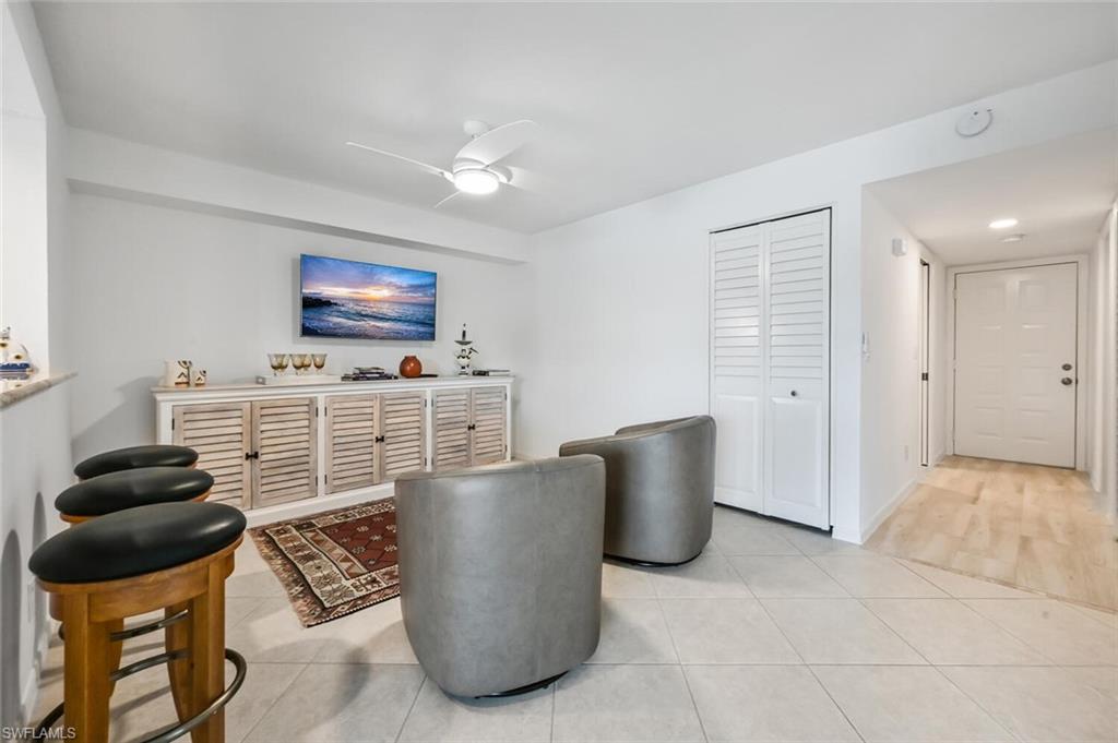 492 Veranda Way, Unit E105 Naples, FL 34104 - Photo 4 of 34 a living room with furniture and a flat screen tv