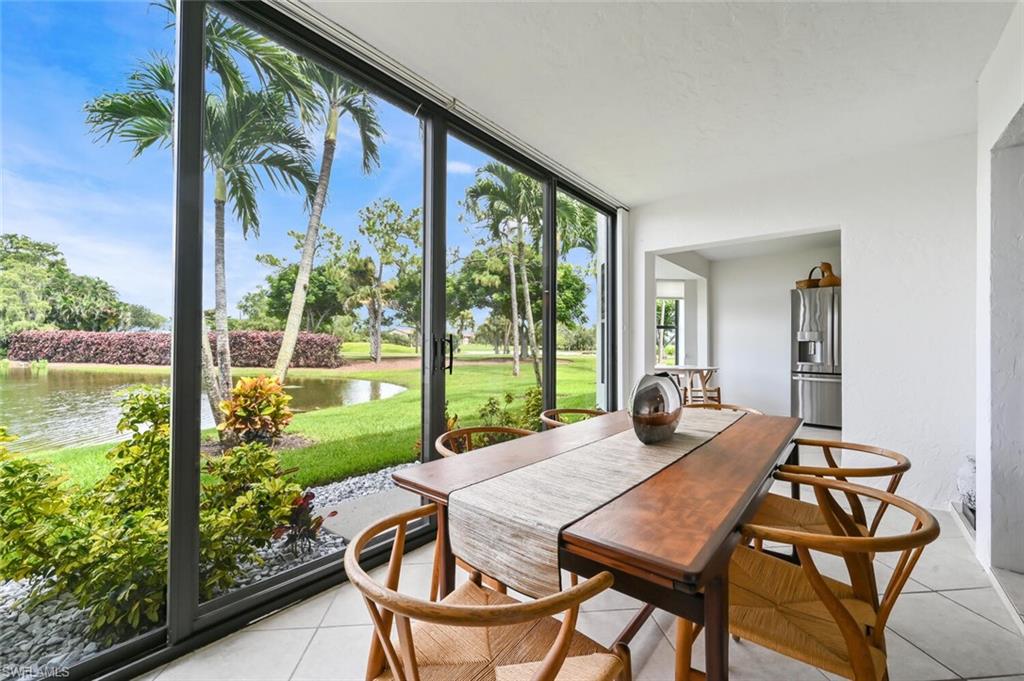 492 Veranda Way, Unit E105 Naples, FL 34104 - Photo 8 of 34 a outdoor dining space with furniture and garden view