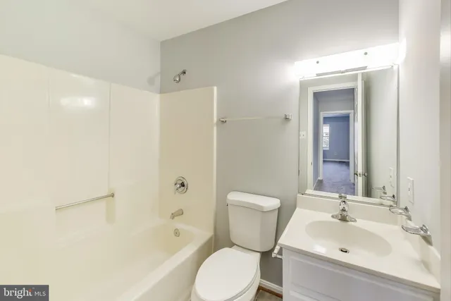 a white toilet sitting next to a bathroom sink and tub
