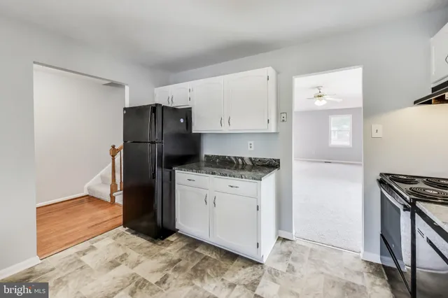 a kitchen with stainless steel appliances granite countertop a refrigerator stove and sink