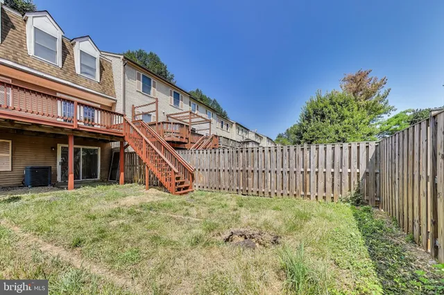 a view of a house with wooden fence