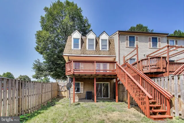 a view of house with front door and deck