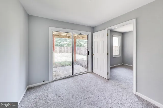 an empty room with sliding glass door