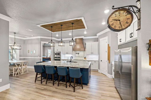 a kitchen with stainless steel appliances cabinets and a window