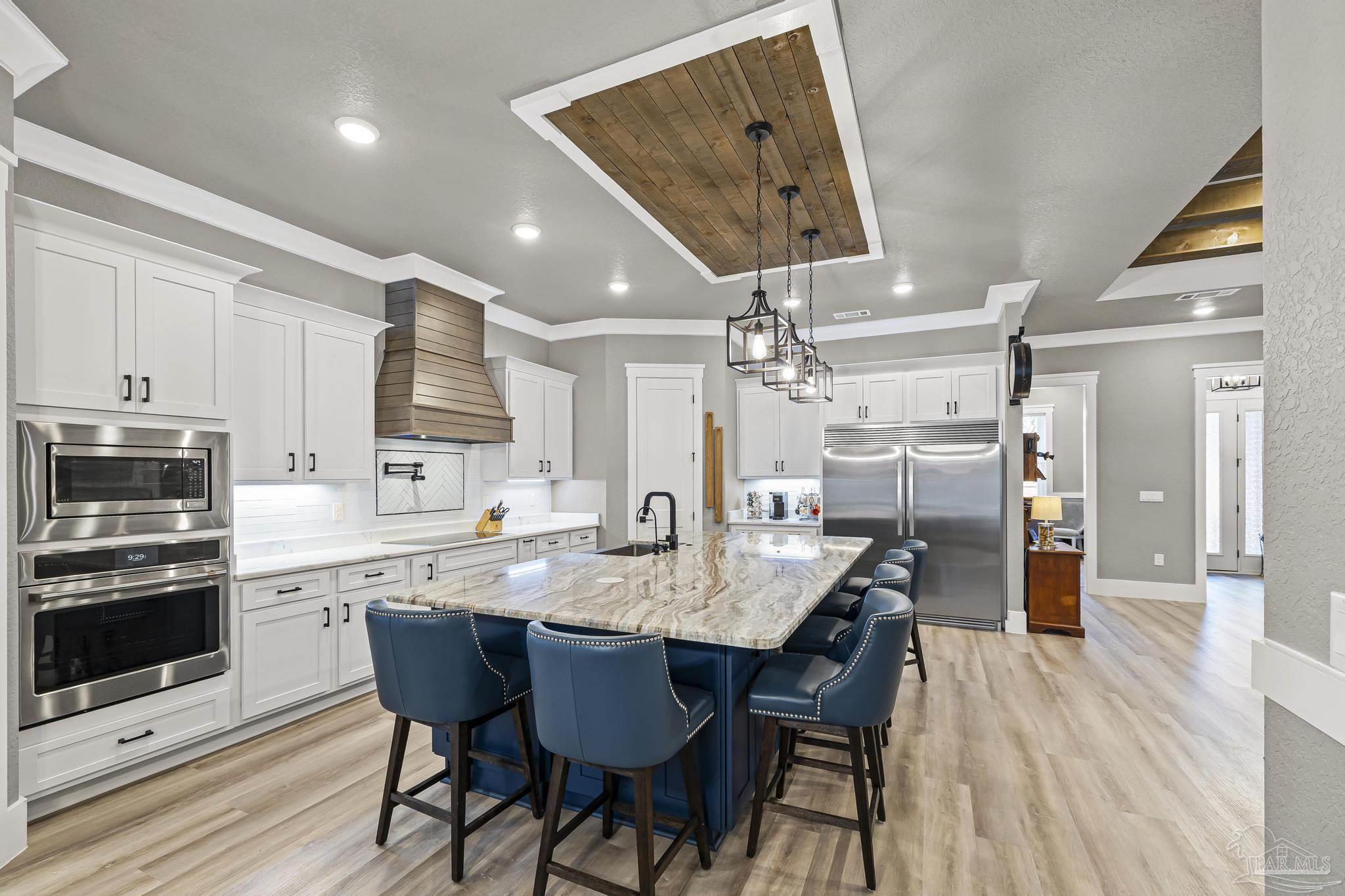 8415 Beulah Road Pensacola, FL 32526 - Photo 16 of 59 a kitchen with stainless steel appliances granite countertop a sink dishwasher and a refrigerator with wooden floor
