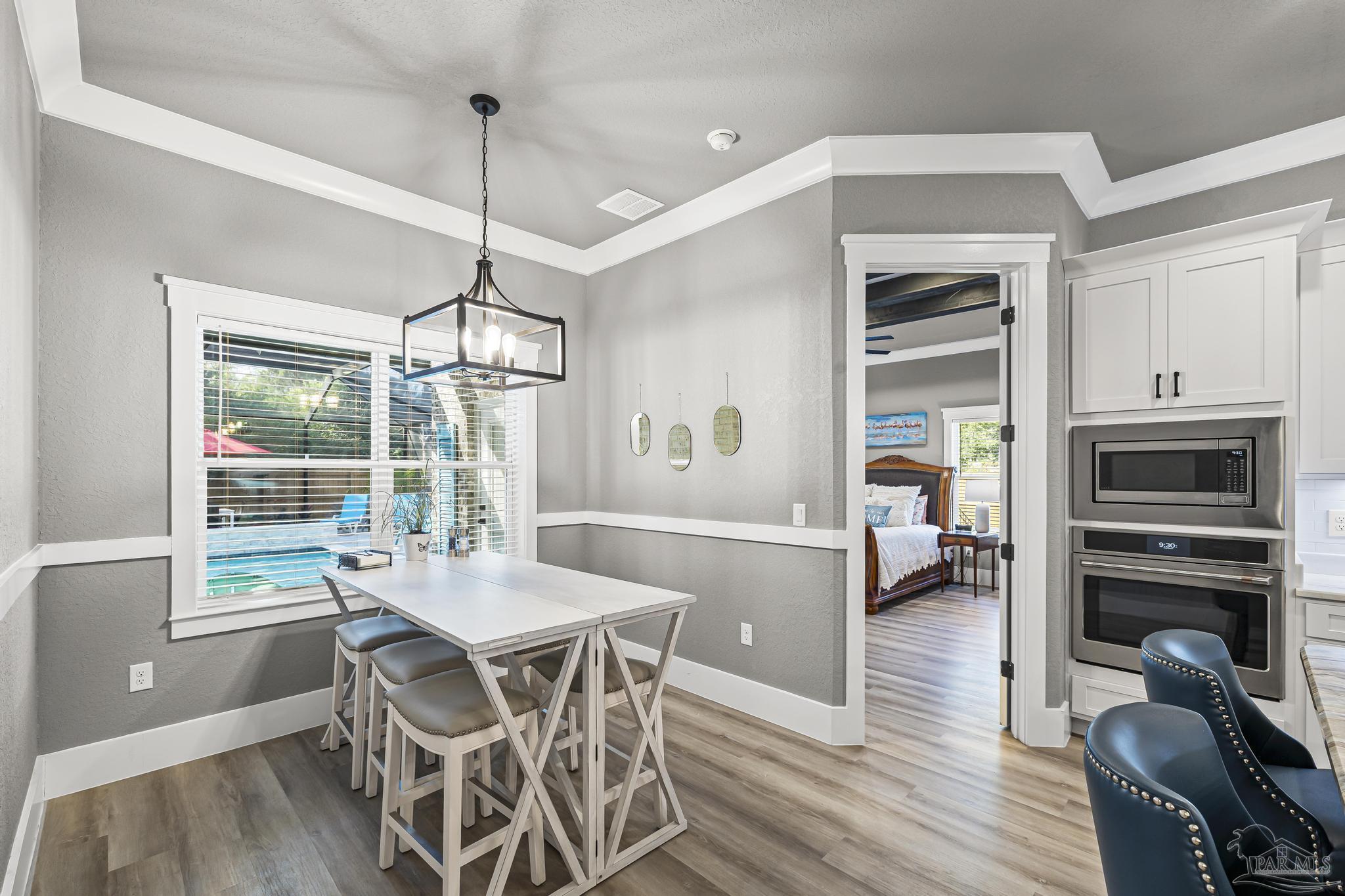 8415 Beulah Road Pensacola, FL 32526 - Photo 18 of 59 a view of a dining room with furniture window and wooden floor