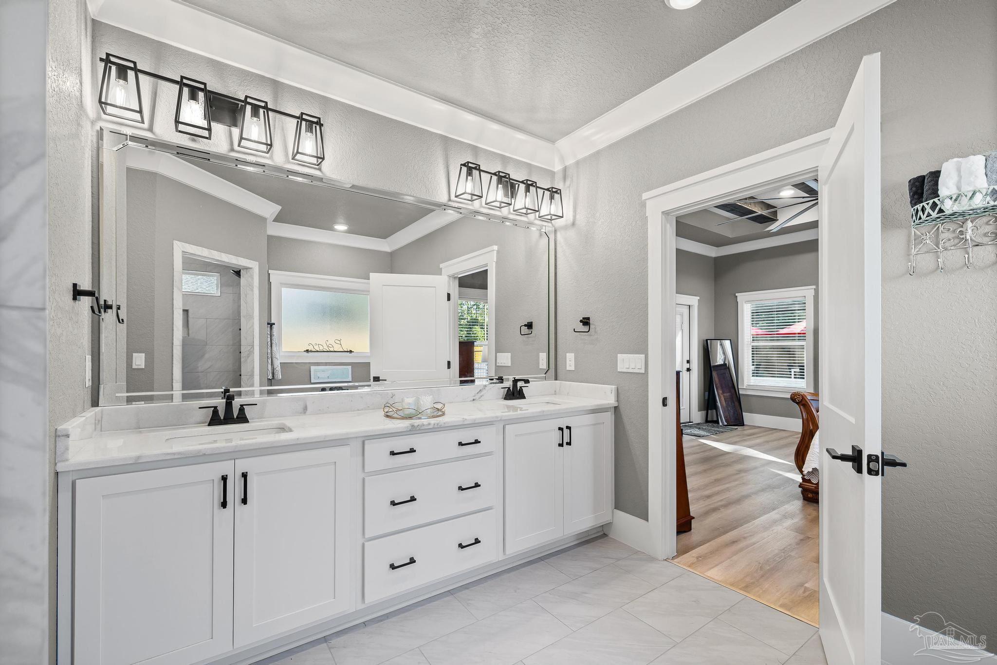 8415 Beulah Road Pensacola, FL 32526 - Photo 23 of 59 a bathroom with a double vanity sink a mirror a vanity and a bathtub