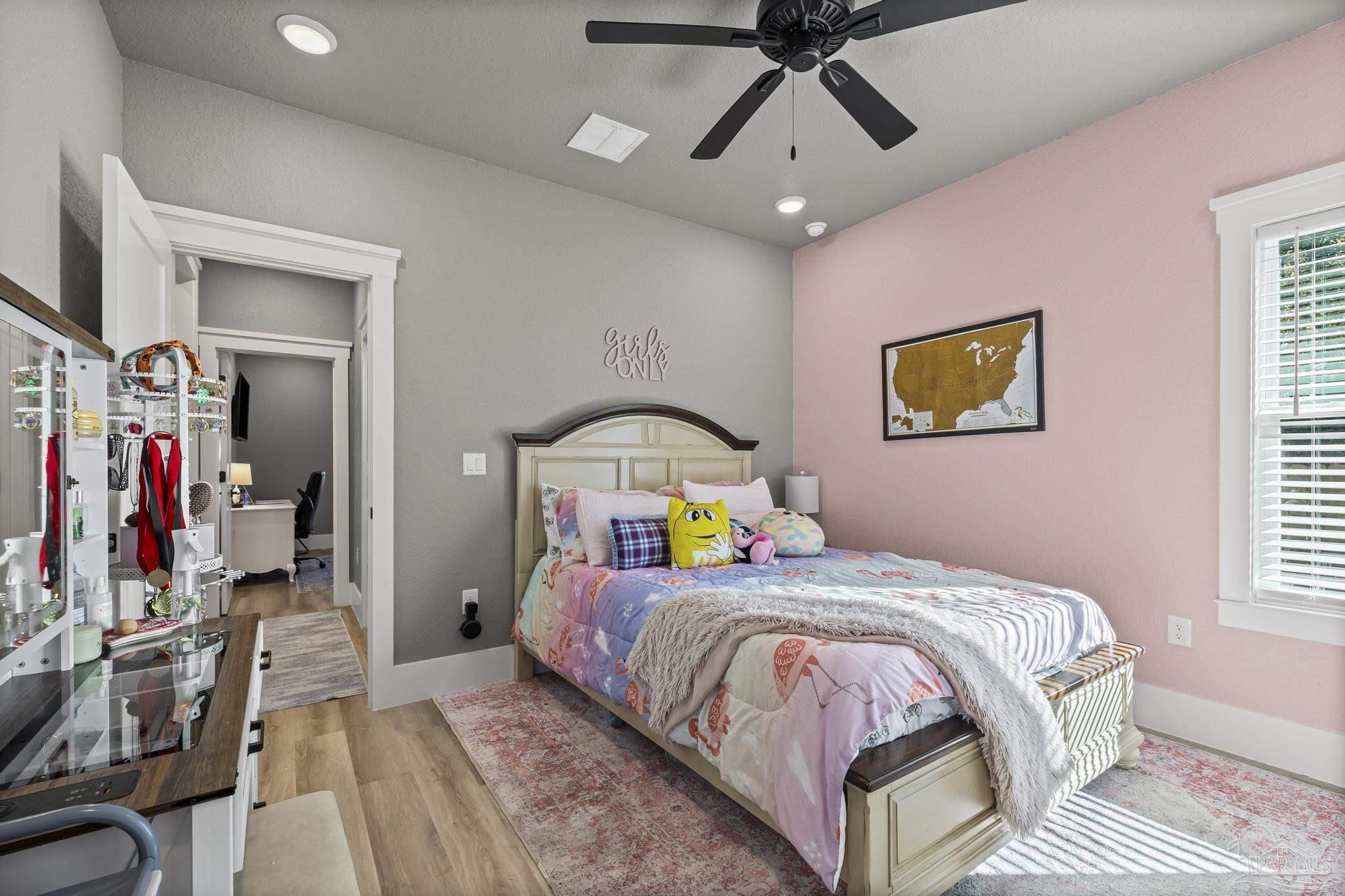 8415 Beulah Road Pensacola, FL 32526 - Photo 31 of 59 a bedroom with a bed and a chandelier