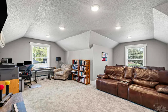 a view of a patio with a table and chairs under an umbrella