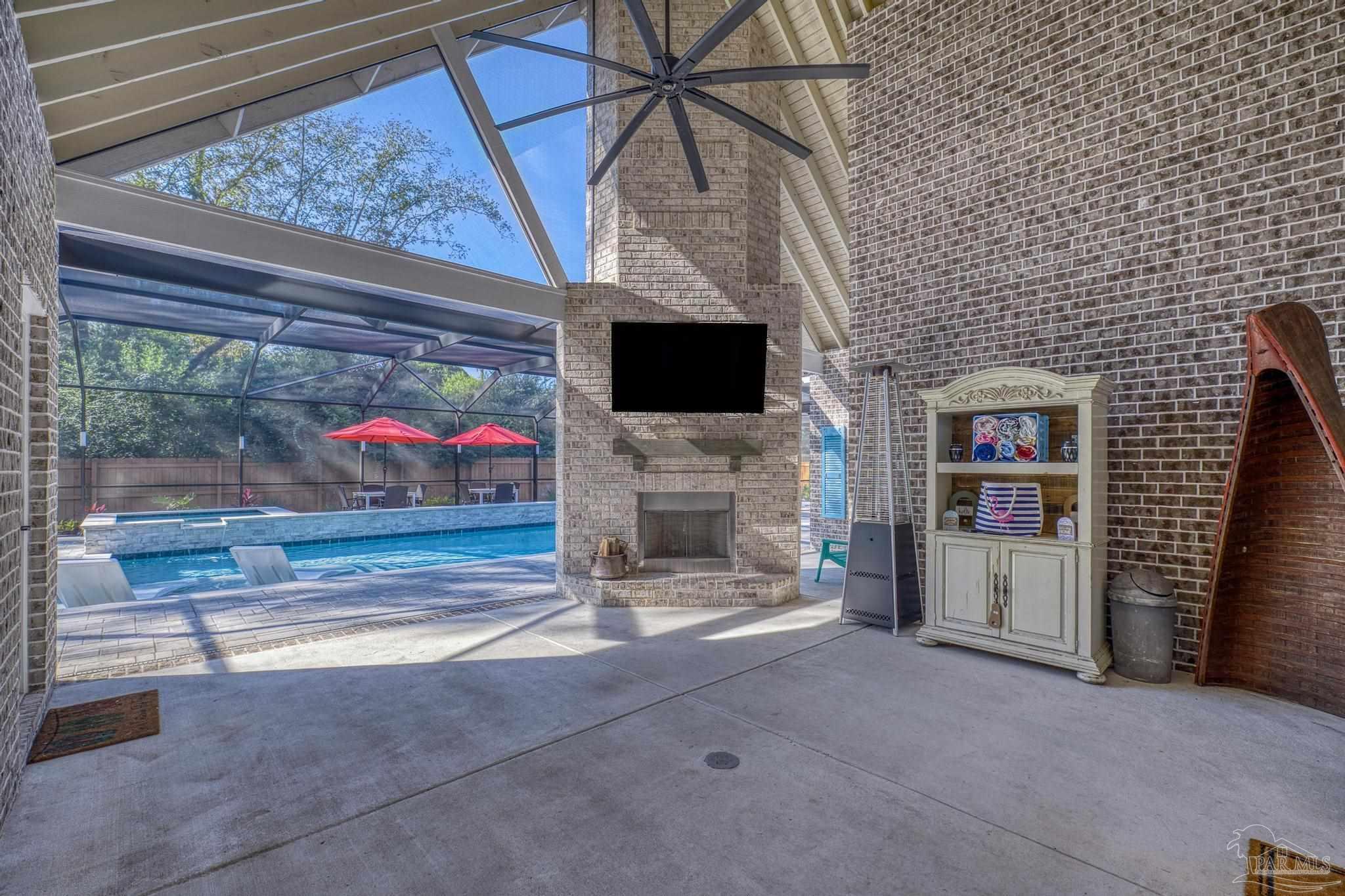 8415 Beulah Road Pensacola, FL 32526 - Photo 39 of 59 a living room with furniture a flat screen tv and a fireplace
