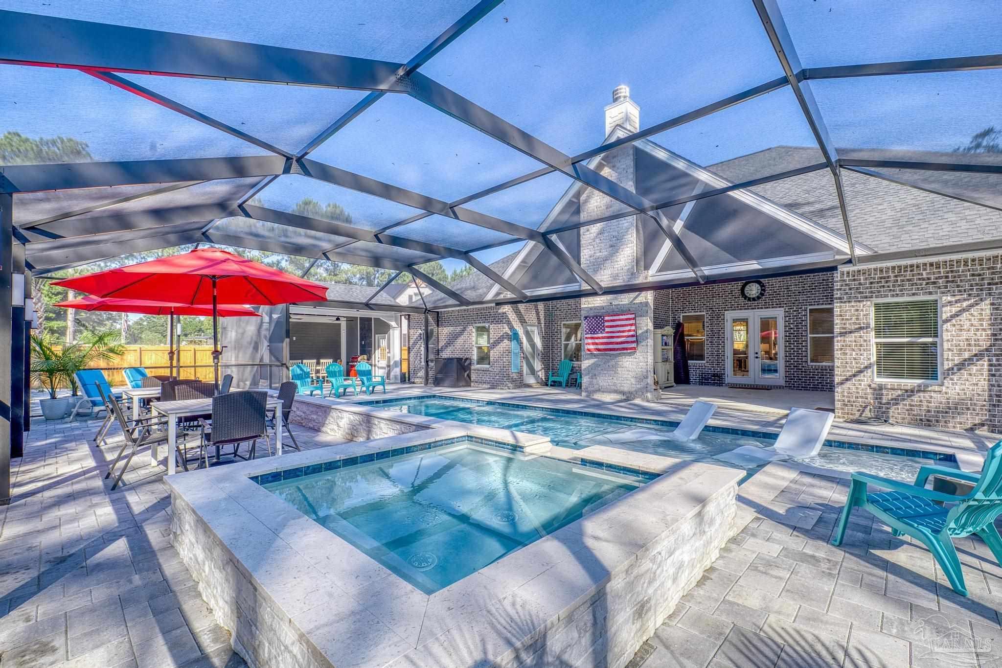 8415 Beulah Road Pensacola, FL 32526 - Photo 40 of 59 a view of a patio with a table and chairs under an umbrella