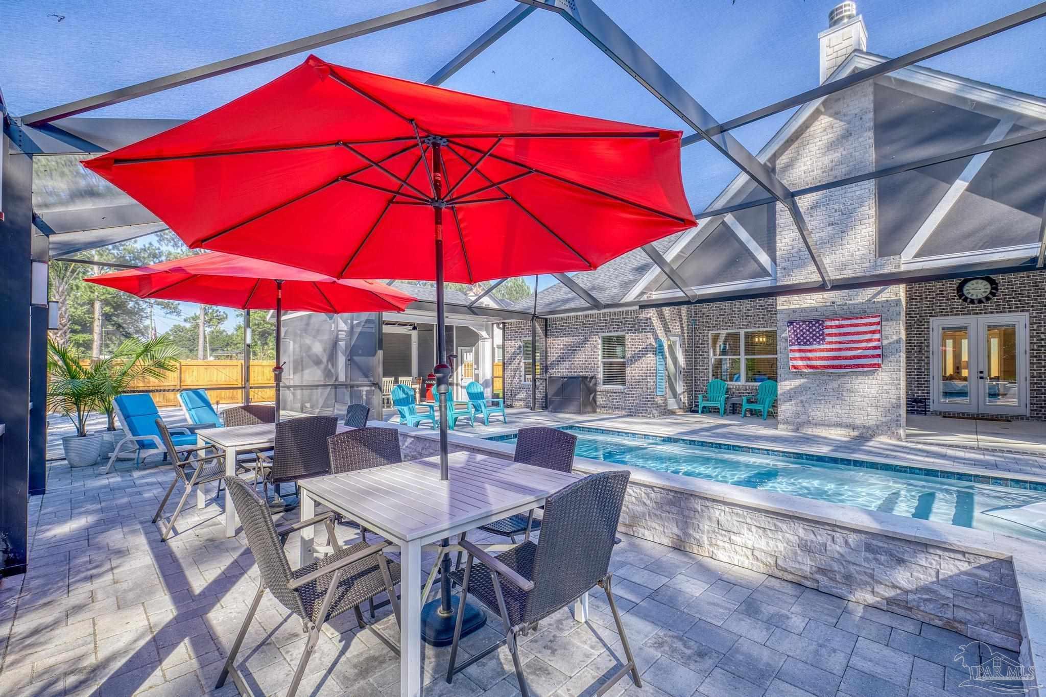 8415 Beulah Road Pensacola, FL 32526 - Photo 41 of 59 a view of a patio with a table and chairs under an umbrella